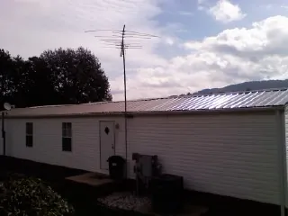 New metal roof on a single wide mobile home with a TV antenna in Chattanooga